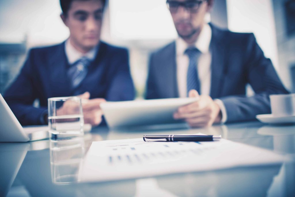 Two businessmen reviewing a report