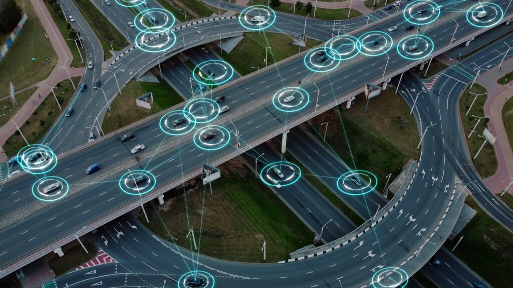 Aerial view of traffic with cars surrounded by blue circles.
